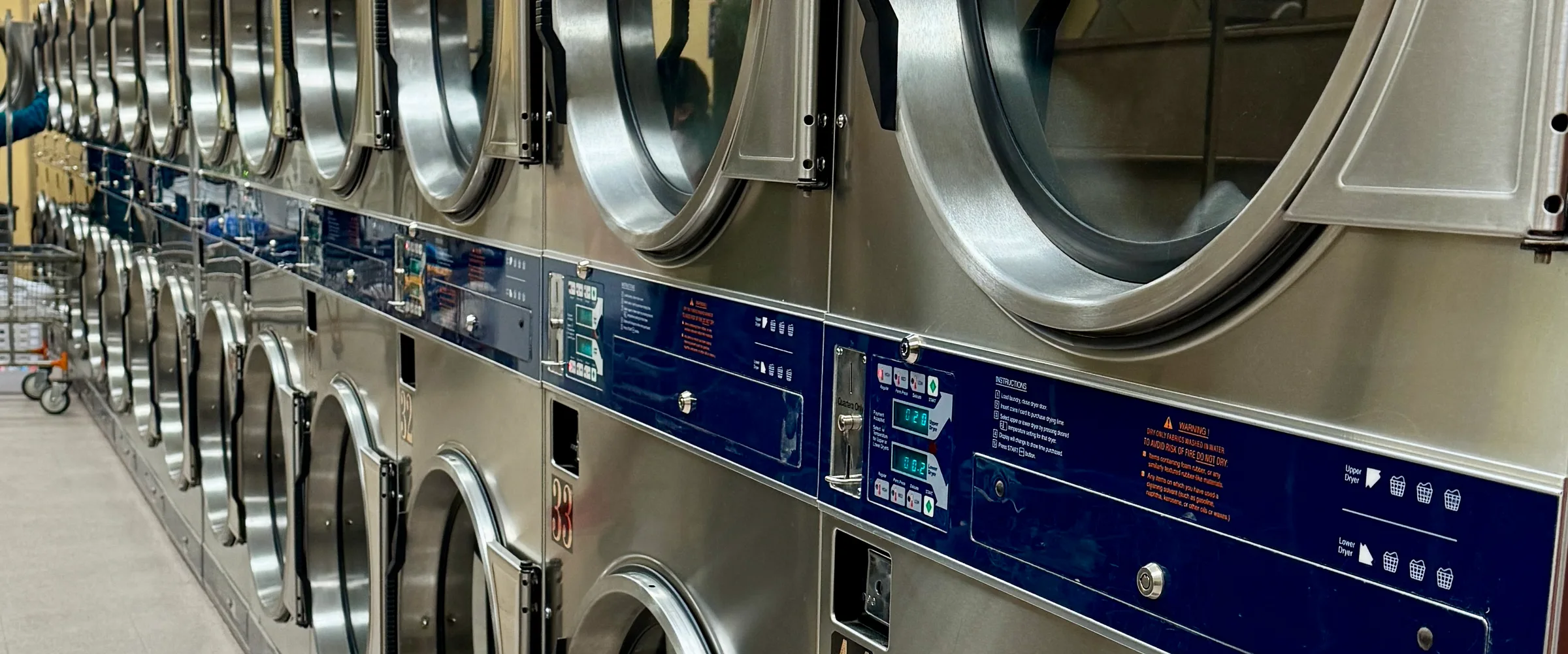 A receding row of dryers at Early Laundry's facility.